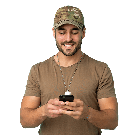 Smiling military service member holding a phone